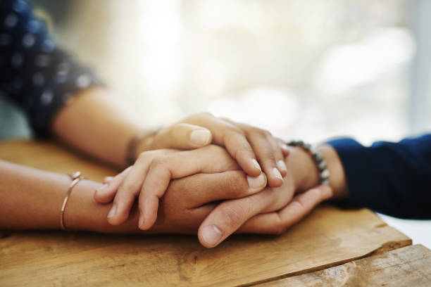 Closeup shot of two people holding hands